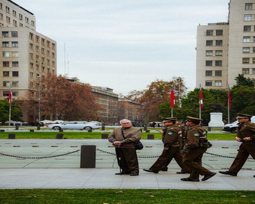 businessman walking calmly in a public park in Santiago