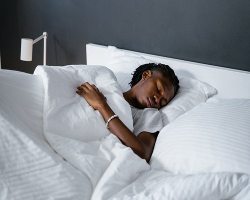 peaceful man sleeping soundly in a comfortable bedroom