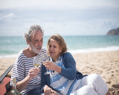 happy and relaxed man sitting by the coast and enjoying life